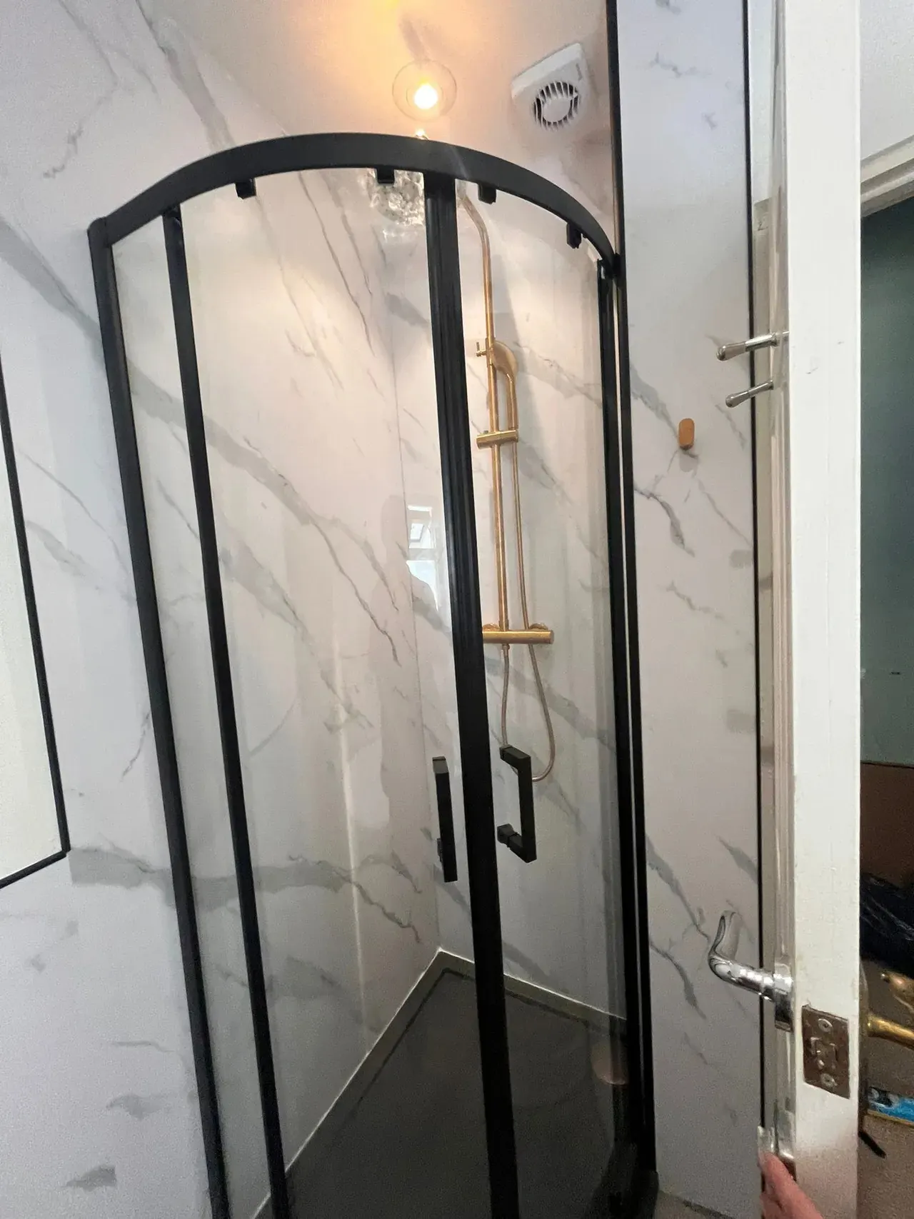 Plumber in Pontprennau fitting a black-framed quadrant shower enclosure