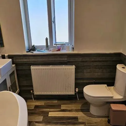 Completed bathroom refit with radiator, toilet and bath in Cardiff