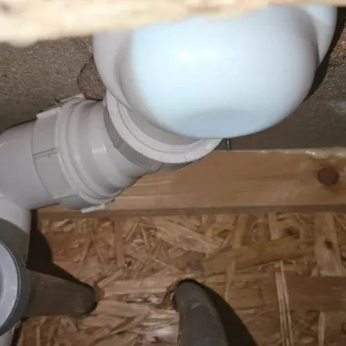 New white waste pipework installed under a bath in a Cardiff home